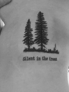 the back of a woman's neck with trees and words on it that says silent in the trees