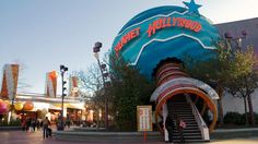 the entrance to planet hollywood with stairs leading up to it and people walking around outside