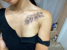 a woman with a flower tattoo on her chest