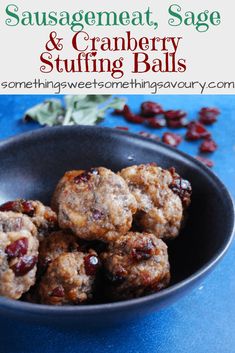 some cranberry and stuffing balls are in a black bowl on a blue table