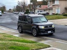 a black suv is driving down the street