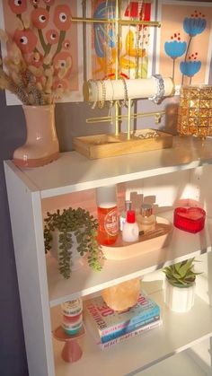 a white shelf with various items on it