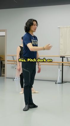 a man and woman standing next to each other in a dance studio