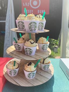 starbucks cupcakes are arranged on three tiered trays