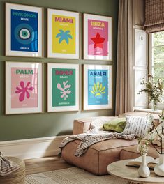 a living room filled with furniture and posters on the wall above it's windows