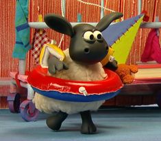 a cartoon sheep riding on top of a toy boat