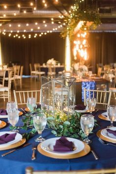 the table is set with plates, silverware and napkins for an elegant dinner