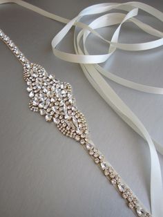 "This sparkly skinny bridal belt is made with the Premium Quality European Crystal beaded on 3/8\" wide satin ribbon. The crystal part of the belt measures 24\" long and the center detail design measures 2\" wide and 5 1/4\" long. The entire sash measures 150\" long. Available in gold, silver and rose gold finish." Beaded Belts, Bridal Accesories, Bridal Sash Belt, Wedding Belt, Crystal Belt, Wedding Sash Belt, Belt Gold, Detail Design, Wedding Sash