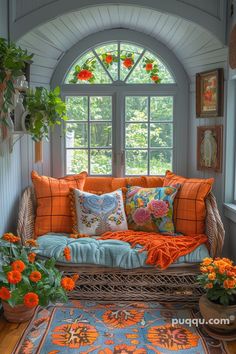 an orange and blue living room with flowers on the window sill next to it