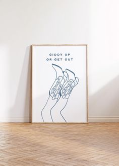 a poster with the words giddy up or get out on it in front of a white wall