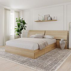 a bed sitting on top of a wooden floor next to a window