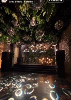 the dance floor is decorated with disco balls and greenery as well as an ad for baub studio