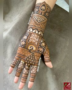 a woman's hand with hennap on it and intricate designs in the middle