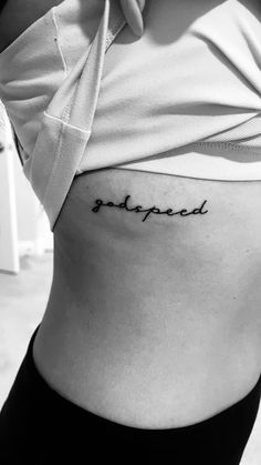 a woman's stomach with the word stopped tattooed on her lower side ribcage