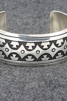 This sterling silver bracelet was made by Navajo silversmith Rosita Singer. The back is signed T&R Singer and stamped sterling.Size: 5 1/2" (will fit a 6 3/4" wrist)Gap: 1 1/4"Length: 1"Free shipping on all orders! We ship with USPS and always include tracking. All orders ship within a day of payment.Returns are accepted up to 30 days after you receive your order. Just send us a message. Our shop offers cash back or store credit. The item must be returned in new condition. Southwestern Silver Bangle Jewelry, Silver Stamped Southwestern Bracelets, Silver Southwestern Stamped Bracelets, Southwestern Silver Engraved Cuff Bracelet, Handmade Southwestern Silver Bracelets, Southwestern Engraved Silver Cuff Bracelet, Southwestern Stamped Silver Bracelets, Southwestern Style Engraved Silver Cuff Bracelet, Silver Southwestern Stamped Cuff Bracelet