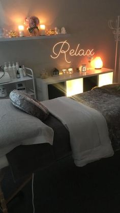 a couple of beds sitting next to each other with candles on top of the bed