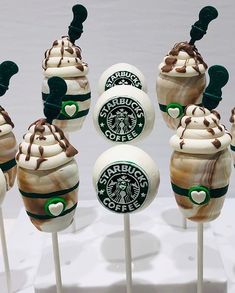 starbucks cupcakes on sticks with white frosting and toppings in the shape of hearts