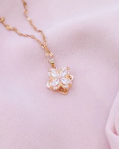 Embrace the grace of spring with our Blossoming Charm Necklace, featuring a delicate crystal flower pendant that sparkles with every turn. Suspended from a dainty gold chain, this necklace is a versatile piece that brings a touch of nature's beauty to your ensemble. It's perfect for layering or wearing solo as a subtle, yet enchanting statement. Need help? Want to purchase a bulk order? Get in touch! ~ Email: contact.aurumgrace@gmail.com ~ Instagram: @AurumGrace All images are copyrighted by Aur Delicate Pendant Crystal Necklace With Clavicle Chain, Elegant Rose Gold Crystal Necklace With Delicate Chain, Elegant Spring Clavicle Chain Jewelry, Feminine Spring Jewelry Gift, Crystal Necklaces With Clavicle Chain And Flower Pendant, Crystal Clavicle Chain Necklace With Flower Pendant, Feminine Flower Charm Jewelry As A Gift For Her, Gold Feminine Necklaces For Spring, Crystal Flower Pendant Necklace With Clavicle Chain