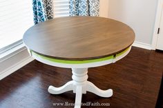 a white and green table in front of a window