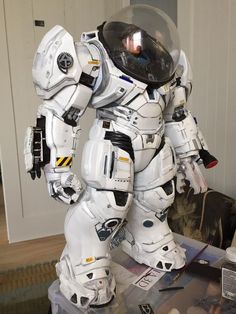 a large white robot standing on top of a table