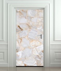 an open door with white and gold stone pattern