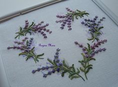 embroidered lavender flowers arranged in the shape of a heart