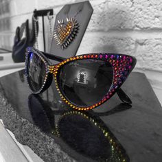 Be the ultimate femme fatale with these sunglasses featuring a sharp cat-eye design. Hand-embellished with hundreds of sparkling crystals around the frame, these luxurious shades will make you feel unstoppable. DETAILS Premium poly-carbonate lenses 100% UV protection | UV 400 protection Complimentary vegan leather case included Made to order. Please allow 2-3 weeks for delivery. Gothic Sunglasses, Embellished Sunglasses, Retro Glasses, Art Walk, Eye Design, Sparkling Crystal, Happy Friday, Leather Case, Cat Eye Sunglasses