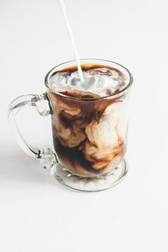 a glass cup filled with liquid and ice