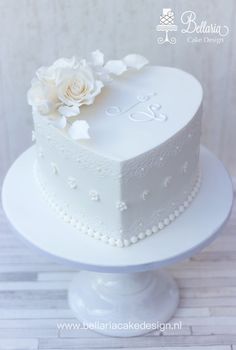 a white wedding cake with flowers on top