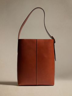 An Italian masterpiece, this sturdy-yet-soft, bonded leather bucket bag uses dark gold signature hardware and contrast stitching to stand above the rest.  Dress it up or down with luxurious ease.  PREMIUM LEATHER: This item is crafted using vegetable Saddle Brown, Signature Hardware, Leather Bucket Bag, Leather Bucket, Dark Gold, Contrast Stitch, Vegetable Tanned Leather, Leather Working, Bucket Bag