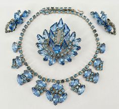 "Vintage Set in Beautiful Sky Blue with open backed Blue crystals and Blue Rhinestones. In Excellent Condition  Necklace 15\" Brooch 2.5\"x2.5\" Earrings 2\" Will arrive in Gift Box" Blue Crystal Brooch Jewelry, Blue Crystal Jewelry Brooch, Blue Crystal Jewelry With Brooch Detail, Blue Jeweled Jewelry For Evening, Jewelry Board, Jewelry Boards, Beautiful Sky, Blue Rhinestones, Vintage Costume Jewelry