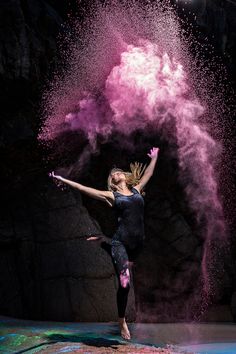 a woman in black shirt and pink powder on her body