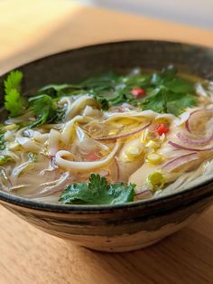 a bowl filled with soup sitting on top of a wooden table