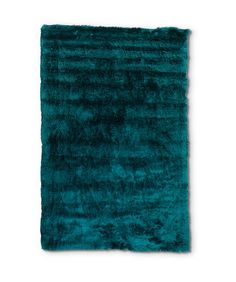 a teal rug on a white background