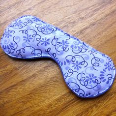 a blue and white eye mask on a wooden table