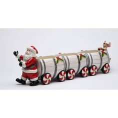 a santa clause riding on the back of a train with candy canes in his hand