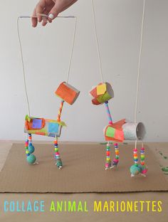 a hand is holding two small toy horses on string attached to the strings that are connected to each other