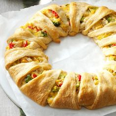 a white plate topped with pastry covered in cheese and veggies