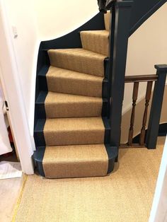 a staircase with carpeted steps leading up to the second floor