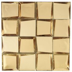 a white and gold tiled wall with squares on the bottom, one square in the middle