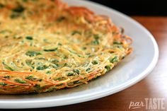 an omelet with spinach and cheese on a white plate