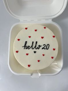 a cake in a box with the word hello - 20 written on it and red hearts