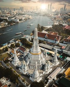 an aerial view of a large white building with many spires in front of the city