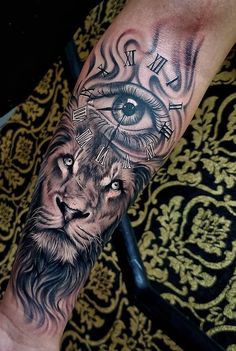 a man's arm with an all seeing eye and lion tattoo design on it