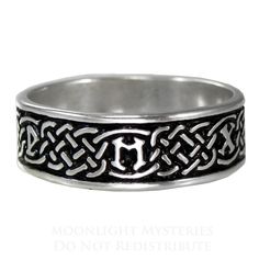 a silver ring with an initial on the middle and a celtic design in the middle