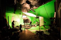 a green screen studio with lights and lighting equipment