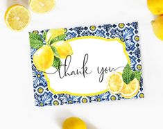 a thank you card with lemons and leaves on the top, surrounded by sliced lemons