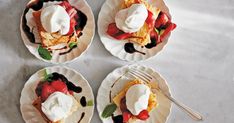 four plates with desserts on them sitting on a table