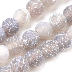 white and gray glass beads on a white background