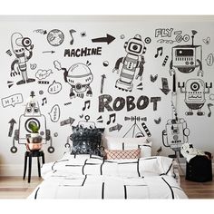 a bedroom with black and white doodles on the wall, including robot decals